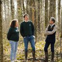 photo of two EcoTree members and a forester in the forest